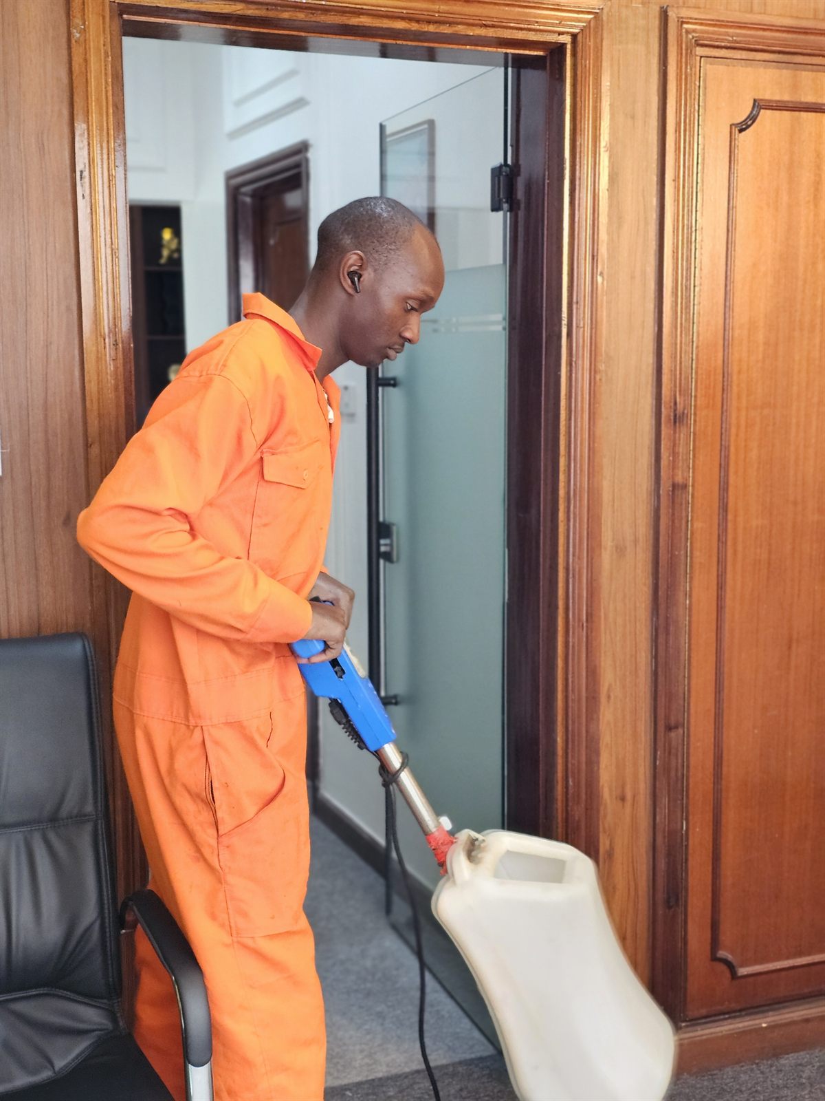 An OnyxHawk crew member in branded uniform cleaning on site in Nairobi